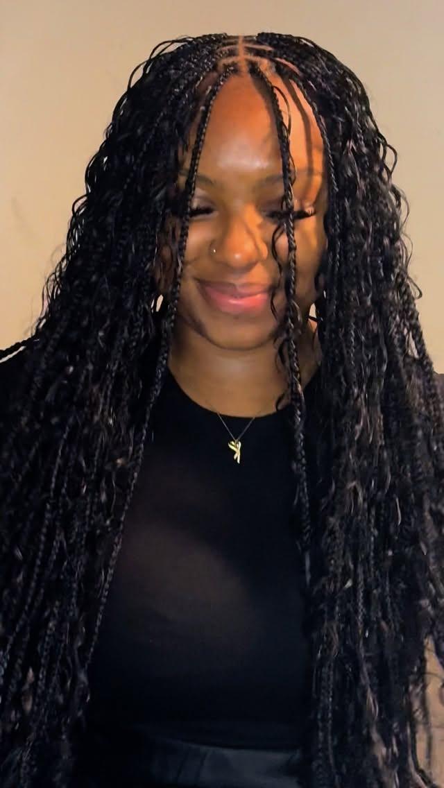Boho braids with soft curls, worn over one shoulder