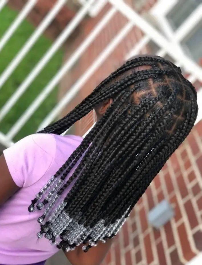 Child wearing gentle knotless braids