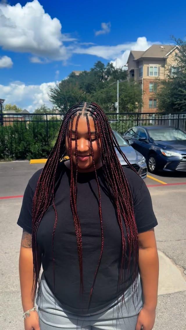 Small knotless braids in a burgundy shade, waist length